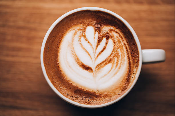 istock Cup of cappuccino on wooden table 626824884