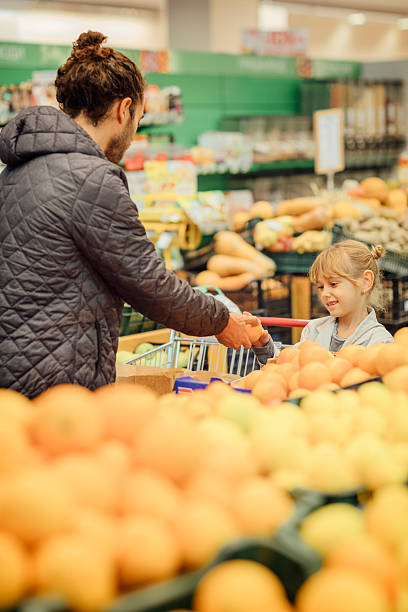 istock Father And His Daughter In A Supermarket. 626826712
