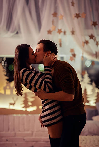 istock Happy lovers together at Christmas eve. Having fun on a 626826932