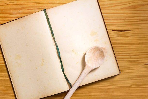 istock Cookbook with cooking spoon on wood 626827216