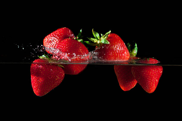 istock Strawberries splashing into water 626827754