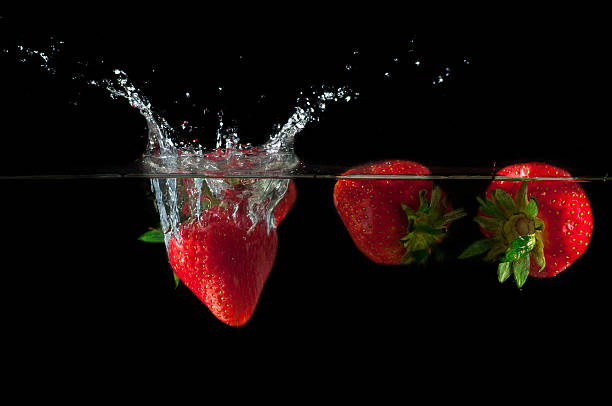 istock Strawberries splashing into water 626827844