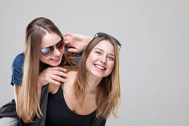 istock Studio portait of young twin sisters embracing 626828422