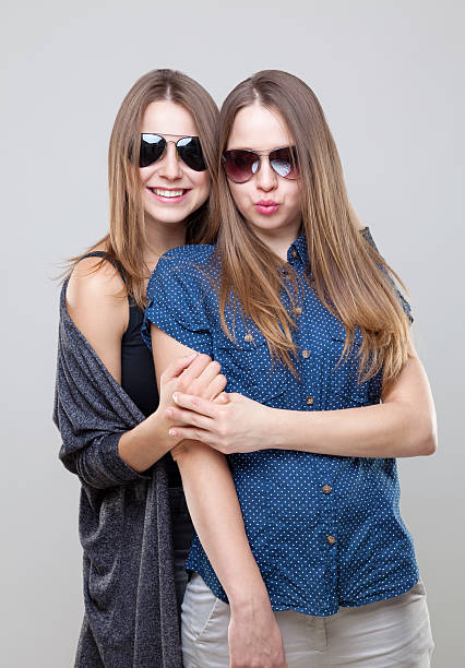 istock Studio portait of young twin sisters embracing 626828584