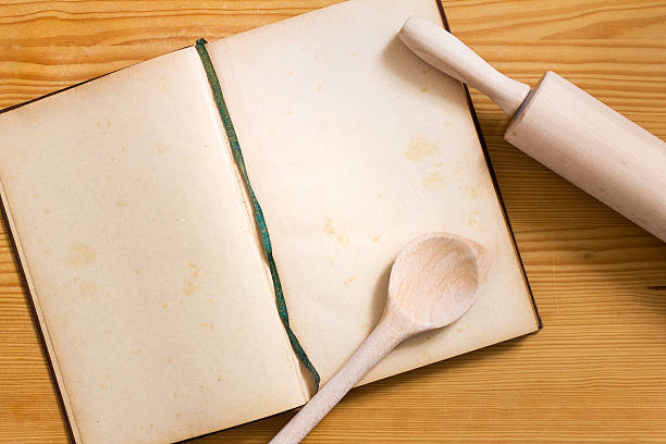 istock Cookbook, cooking spoon and rolling pin on wood 626828782