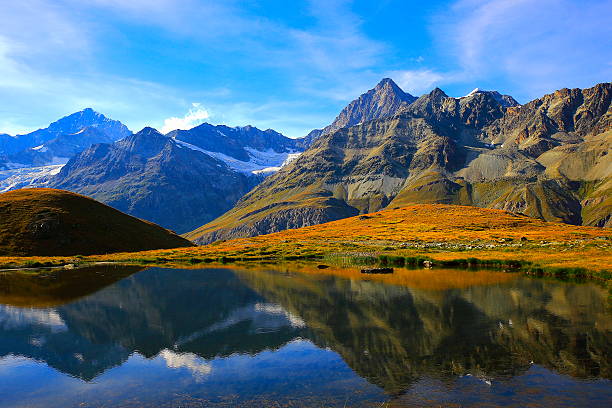 istock Swiss alps landscape: Alpine Lake reflection, golden meadows above Zermatt 626831472