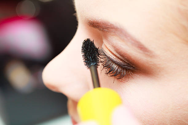 istock Close up woman getting make up, mascara 626838152