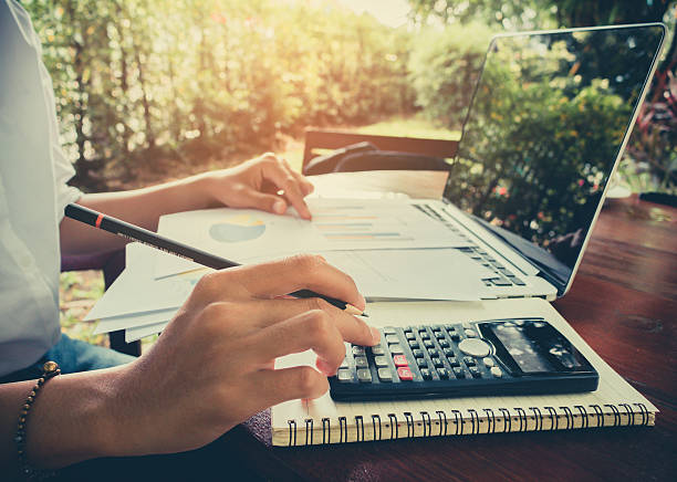 istock business woman calculate and analyzing graph document financial 626838282