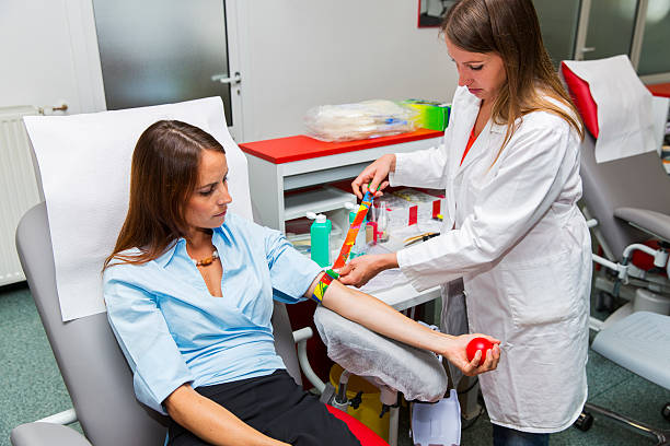 Young woman is going to donate blood in  blood bank Young woman is going to donate blood in a blood bank,young woman doctor making prepairs blood bank stock pictures, royalty-free photos & images