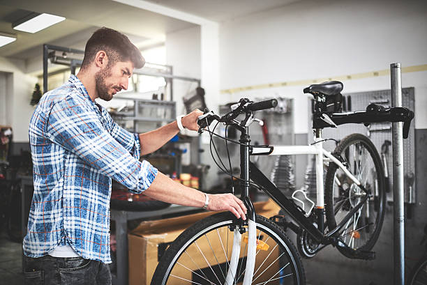 istock Mechanic repairing bicycle 626839348