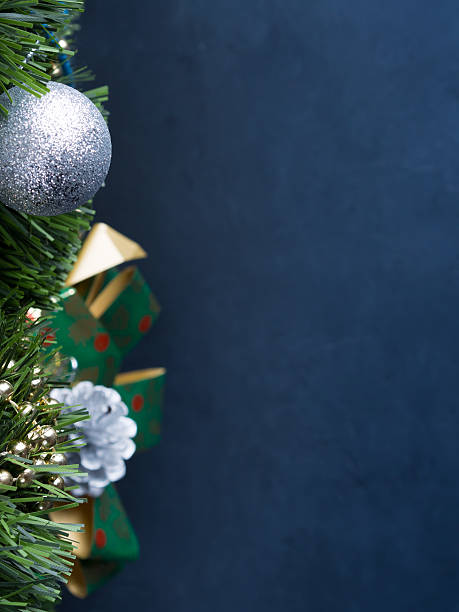 istock Dark vertical Christmas background with baubles and bow 626839556