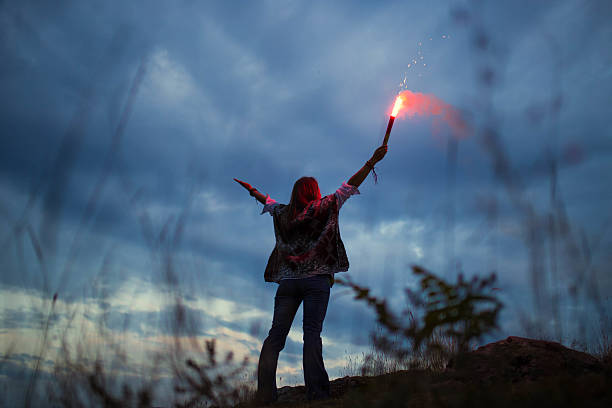 istock Woman holding a flaming torch 626839938