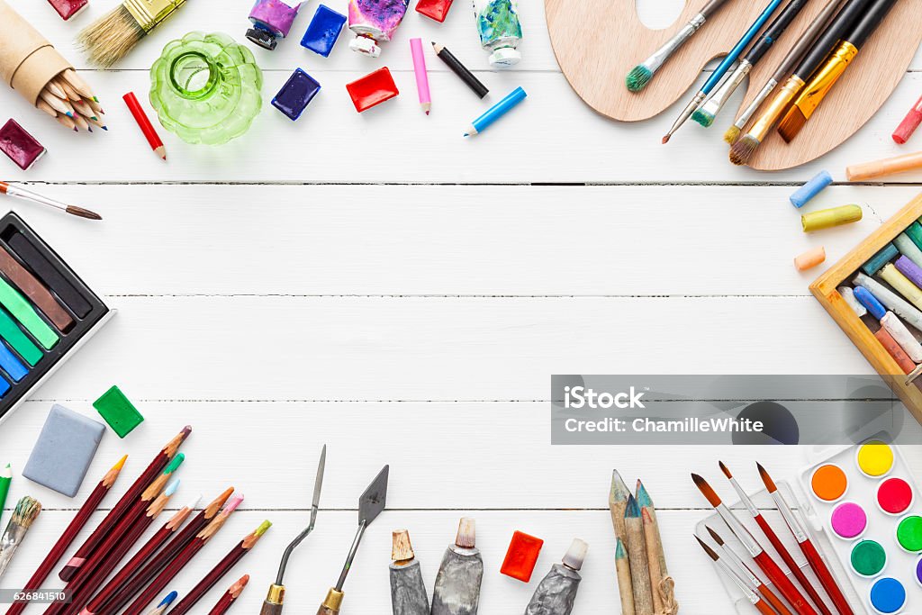 Watercolor and oil paints, brushes, pencils, pastel crayon on table. Watercolor and oil paints, brushes for painting, pencils, pastel crayon on white table. Top view. Flat lay. Art And Craft Stock Photo