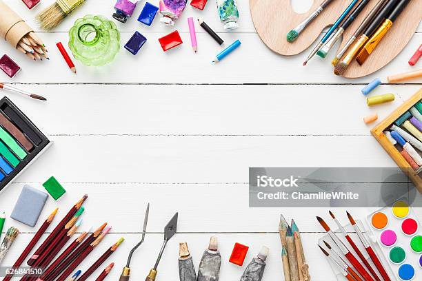 Watercolor And Oil Paints Brushes Pencils Pastel Crayon On Table Stock Photo - Download Image Now