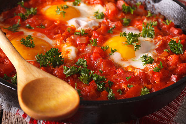 istock Breakfast shakshuka fried eggs with tomato sauce macro. horizontal 626842080