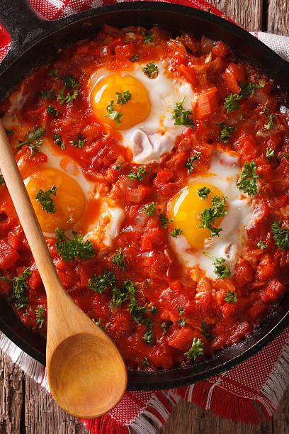istock Shakshuka fried eggs macro in frying pan. vertical top view 626842664