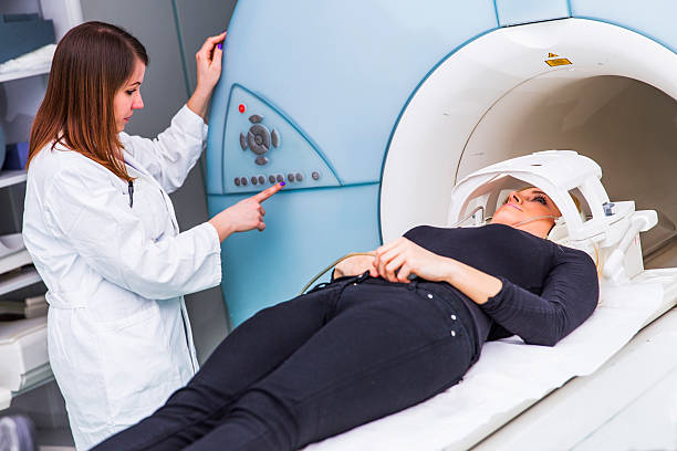istock Young woman waiting for CAT scan 626844126