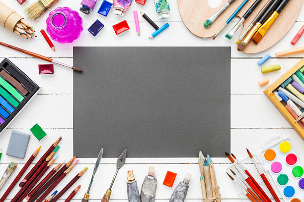 istock Paints, brushes, pencils, pastel pastel crayon and gray paper sheet. 626845614