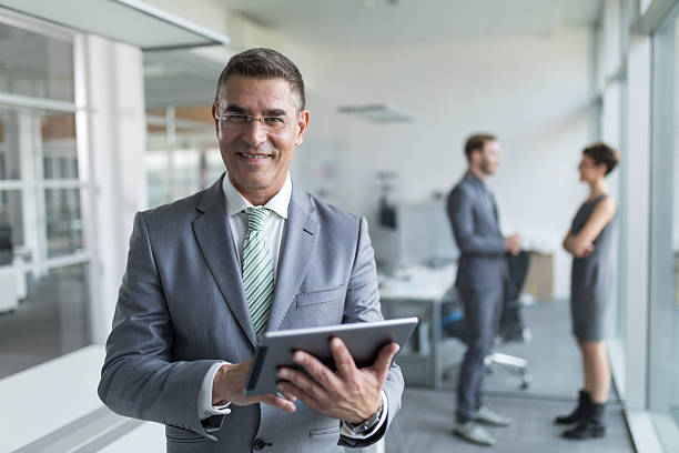 istock Mature businessman using digital tablet in the office 626850494