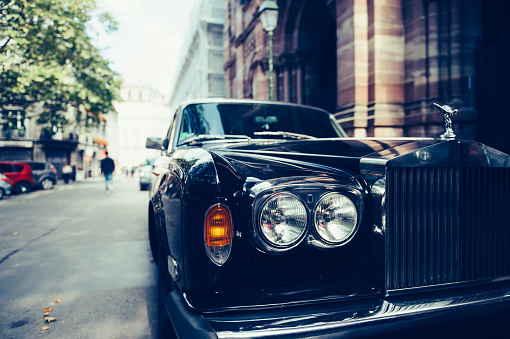 Paris, France - September 12, 2016: Front view of Exclusive Luxury Rolls-Royce car limousine parked in city during fashion wedding vip event waiting for passenger. Rolls-Royce Limited is a British car-manufacturing and, later, aero-engine manufacturing company founded by Charles Stewart Rolls and Sir Frederick Henry Royce on 15 March 1906 as the result of a partnership formed in 1904.