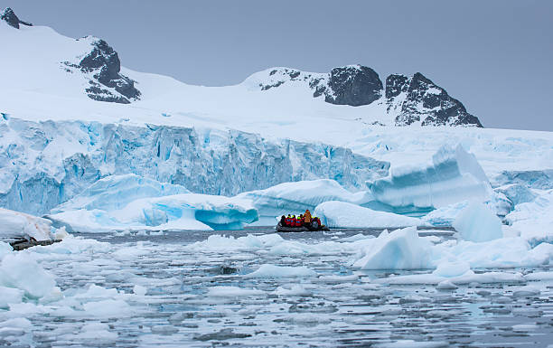 istock Boat with tourists floating amongst Icebergs in Antarctica 626851376