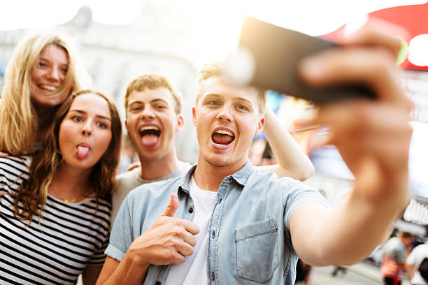 istock friends take a selfie in piccadilly circus 626851780