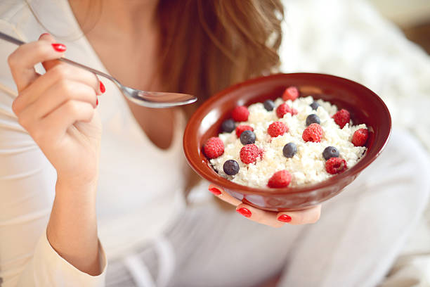 istock woman eats cottage cheese with berries 626854056