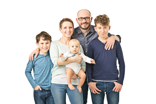 Portrait of happy mid adult parents with son and daughter looking at the camera.
