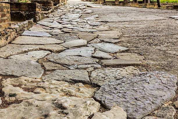 Ancient Roman road in Italica. Street in the Roman ruins of Italica. Santiponce. Sevilla. Spain. italica spain stock pictures, royalty-free photos & images
