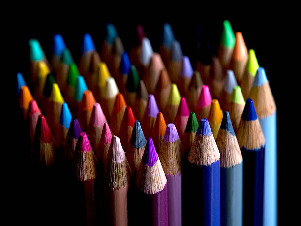 Coloured pencils on black background stock photo