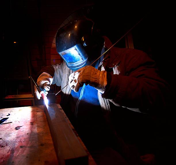worker welding construction by stock photo