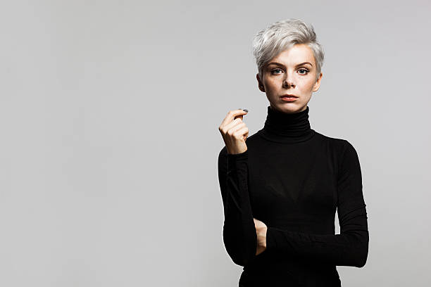 Confident Young Enterpreneur Portrait og young woman with short gray hair wearing a black turtleneck sweater. Looking confident. turtleneck photos stock pictures, royalty-free photos & images