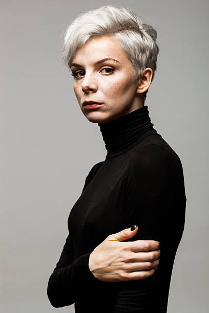 Portrait of Young Woman Portrait of young woman with gray short hair looking at camera. gray hair young woman stock pictures, royalty-free photos & images