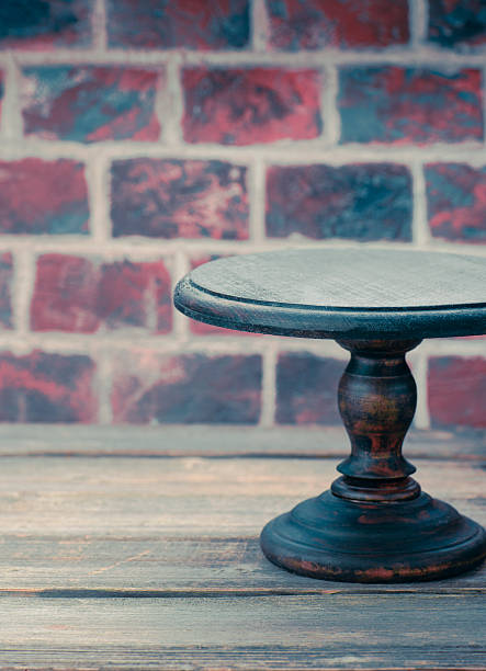 istock Cake plate on vintage wooden table over brick wall background 626865720