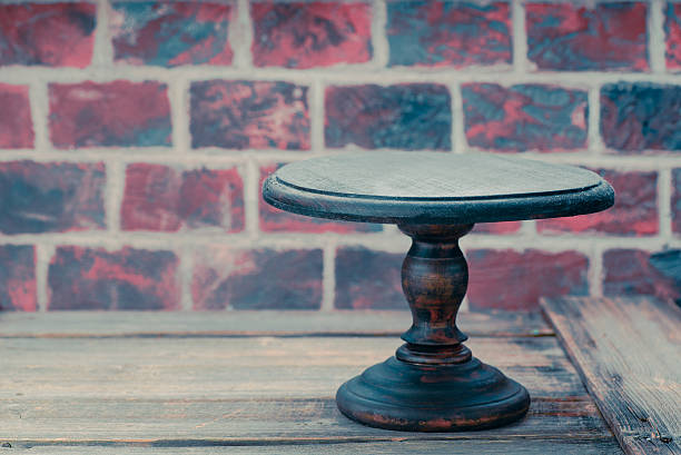istock Cake plate on vintage wooden table over brick wall background 626865770
