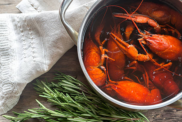 istock Pot with boiled crayfish on the wooden table 626865978
