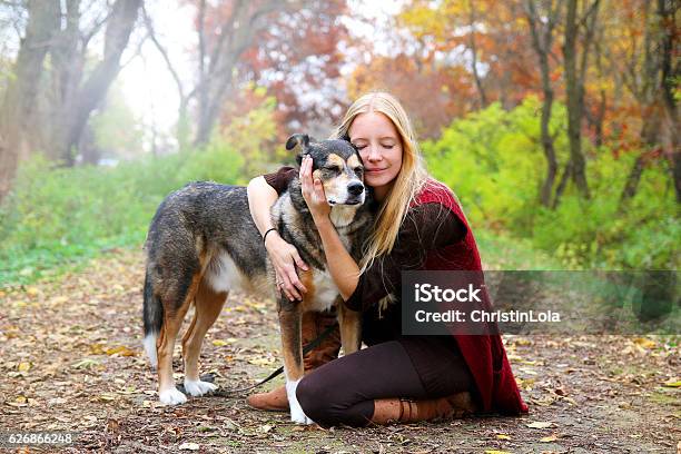 Peaceful Happy Woman Hugging German Shepherd Dog While Stock Photo - Download Image Now