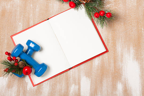 istock Christmas sport composition with dumbbells, notebook, berries and spruce 626867756