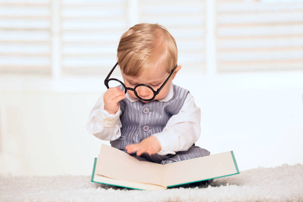 Nerdy baby boy reading a bookNerdy baby boy reading a book