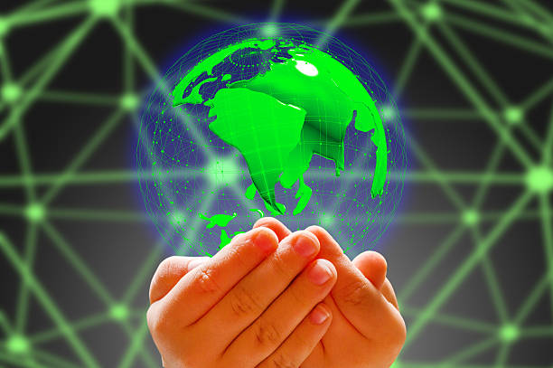 istock kid's hand holding globe in dark background 626875066