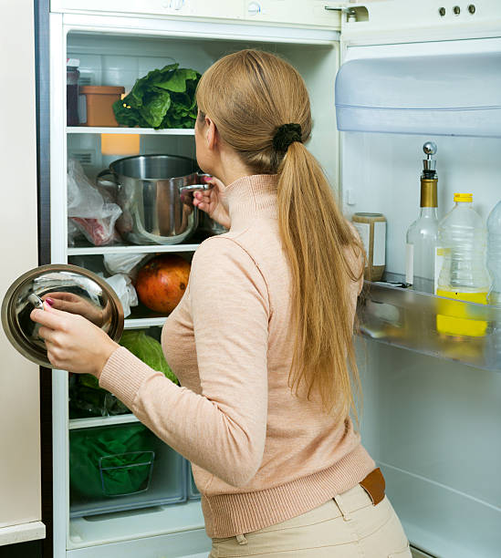 istock Satisfied housewife near filled fridge 626875344