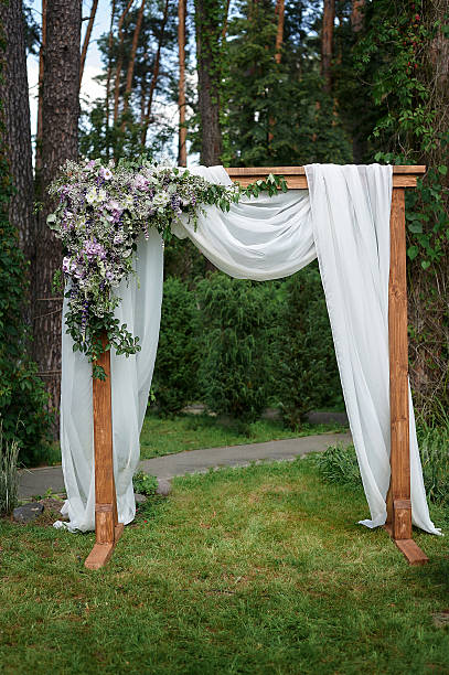 istock Beautiful wedding arch decorated with flowers in the Park 626890404