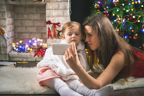 istock Mother and Daughter Take a Selfie at Christmas 626890622