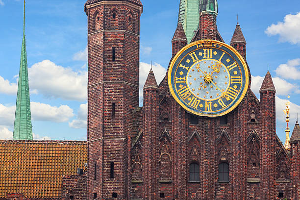 St Mary's Church in Gdansk Detail of the facade, clock, and tower of St Mary's Church in Gdansk, Poland. The church was completed in 1502, and is one of the largest brick churches in the world. gdansk stock pictures, royalty-free photos & images