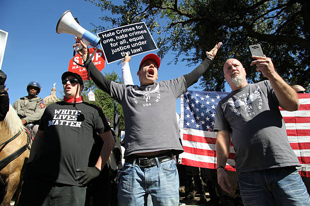Bradford, UK - August 28, 2010: EDL supporter confronts policemen at the English Defence League rally in Bradford. The EDL, a far right group, held a rally in the city of Bradford which has a large Muslim population.