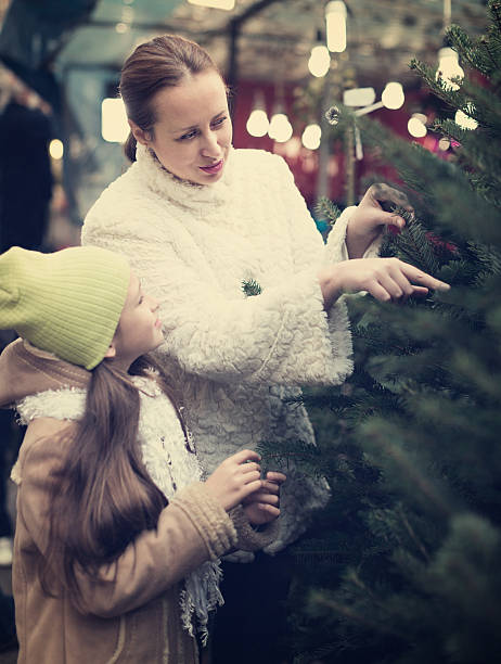 istock mother and daughter choose tree 626901720