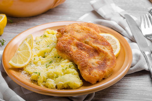 Schnitzel with parmesan crust and mashed potatoes parmesan