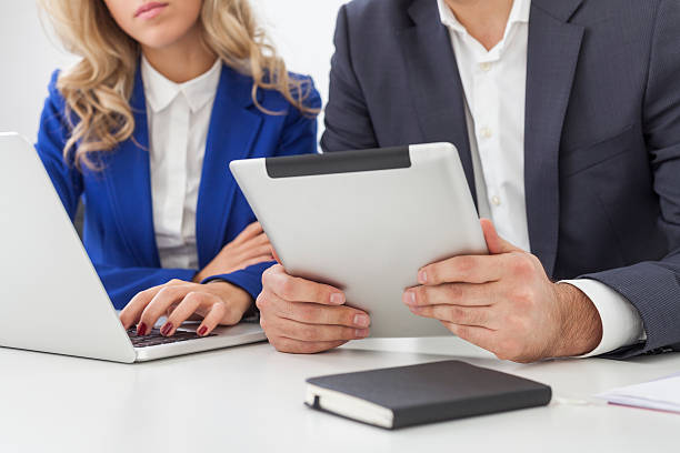 istock man's hands with a tablet sitting near a girl 626907668