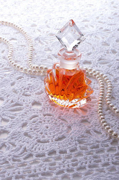 istock Perfume bottle and pearl jewellery on lace background 626912320