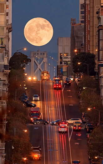San Francisco California street, bay bridge and supermoon on the background.